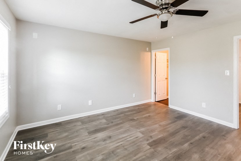 a empty living room with a ceiling fan
