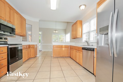 A kitchen with wooden cabinets and a refrigerator.