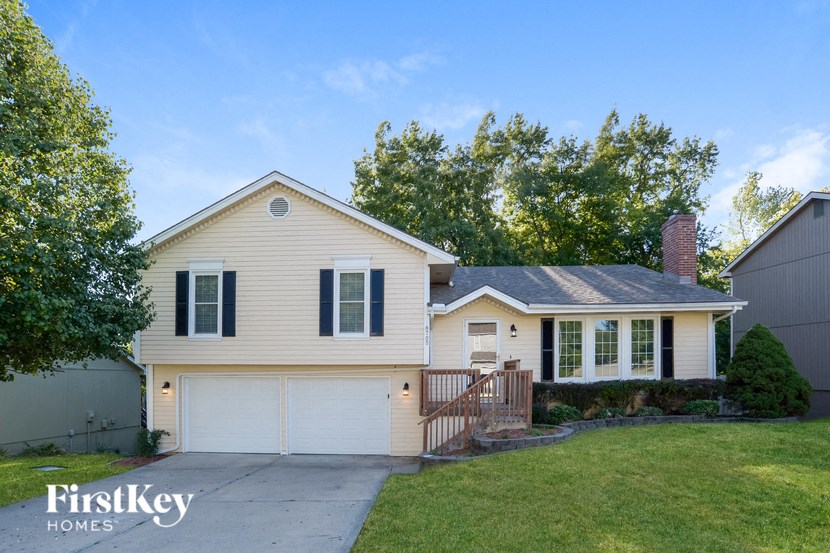 A two-story house with a garage is for sale.
