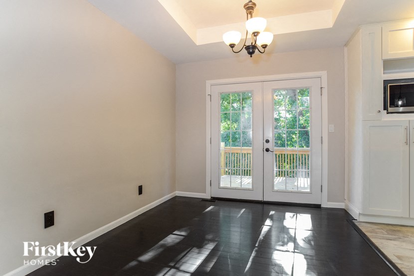 A room with a slanted ceiling and a chandelier.
