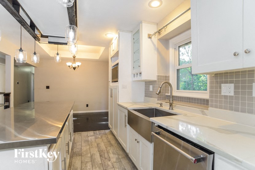 A kitchen with a stainless steel sink and dishwasher.