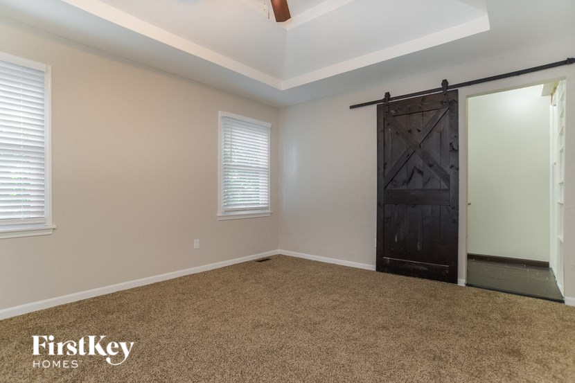 A room with a sliding door and a ceiling fan.