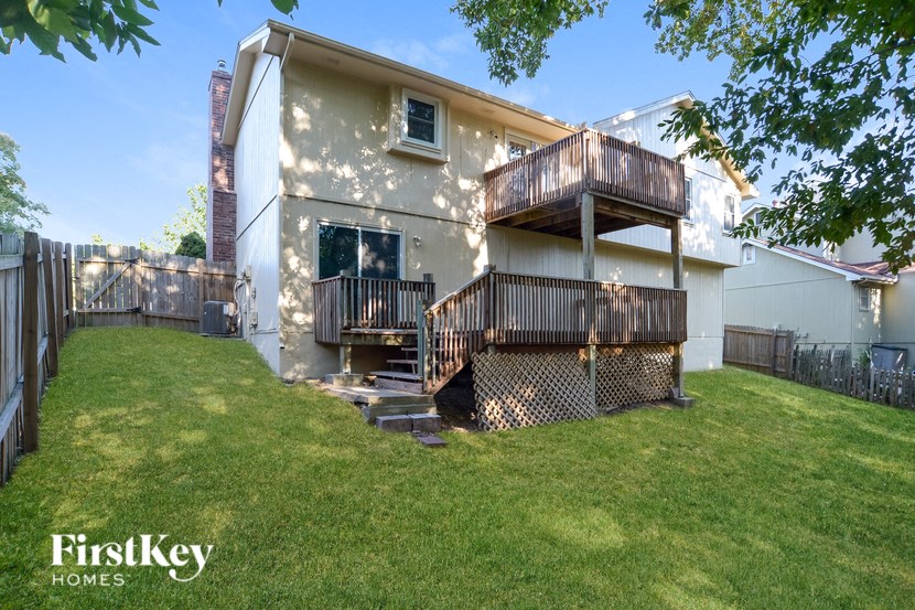 A house with a balcony and a deck is for sale.