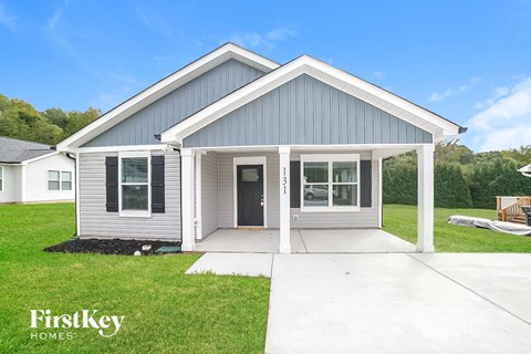 A modern house with a grey and white exterior is for sale by FirstKey Homes.