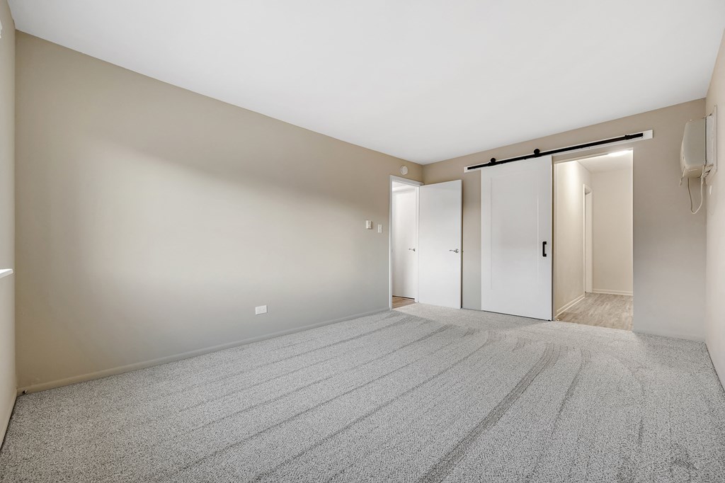an empty living room with white walls and a carpeted floor