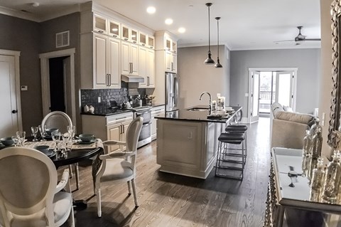 A modern kitchen with a dining table set for four.