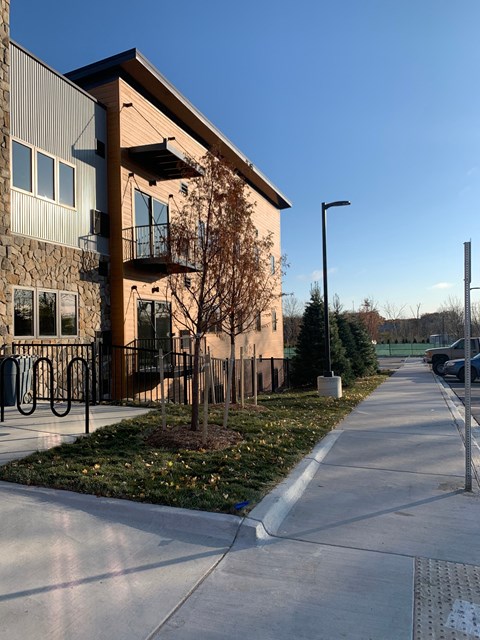 A modern building with a bicycle rack in front.