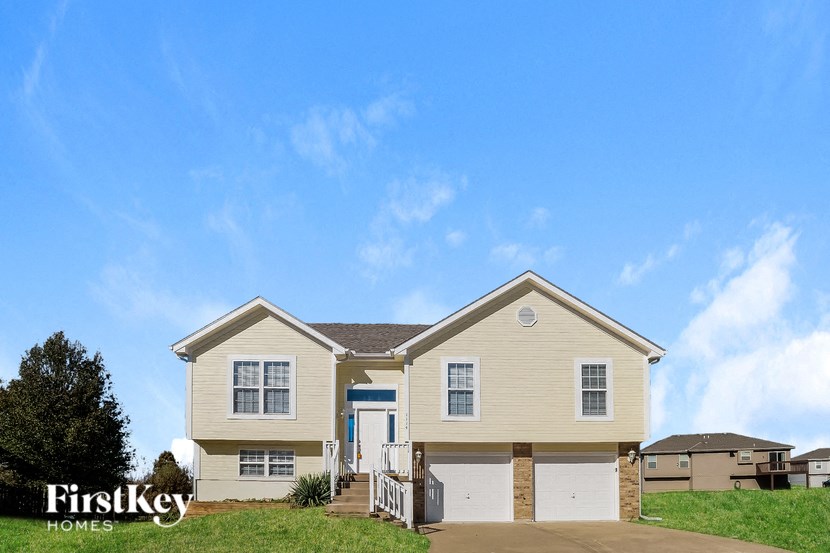 A two-story house with a garage is for sale by FirstKey Homes.