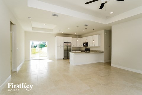 the kitchen and living room are spacious and open to the backyard