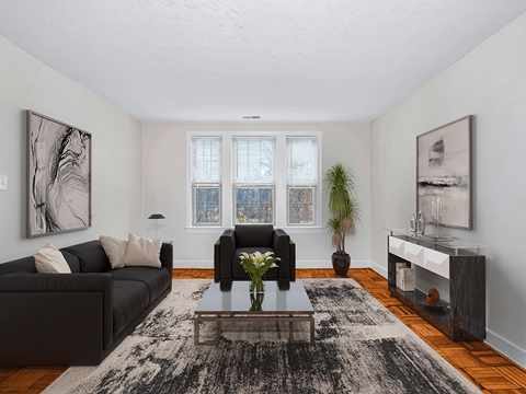 a living room with a black couch and a coffee table