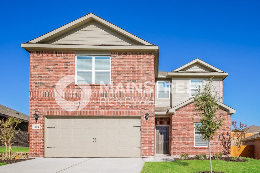 a brick house with a garage door on the side