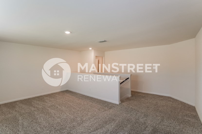 a room with carpet and a desk