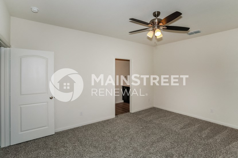 a bedroom apartment with a closet and a ceiling fan