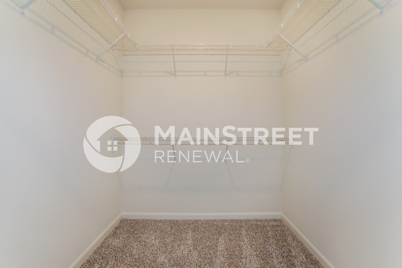 a small room with a carpeted floor and a window