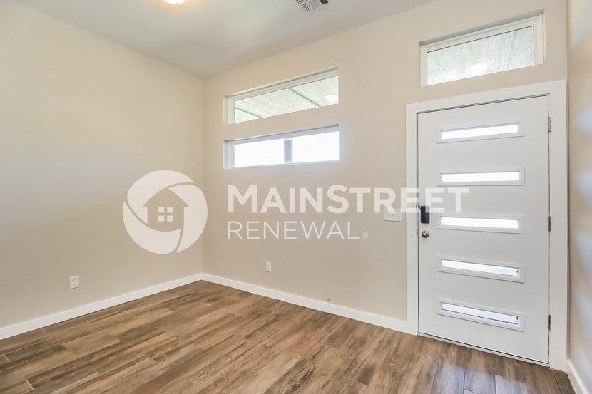 a bedroom with a white door and a window