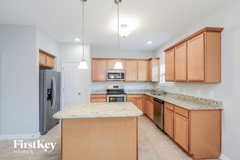a kitchen with wooden cabinets and granite counter tops