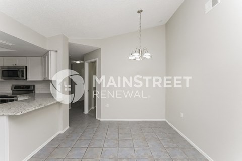 a renovated kitchen with a large island and an open floor plan