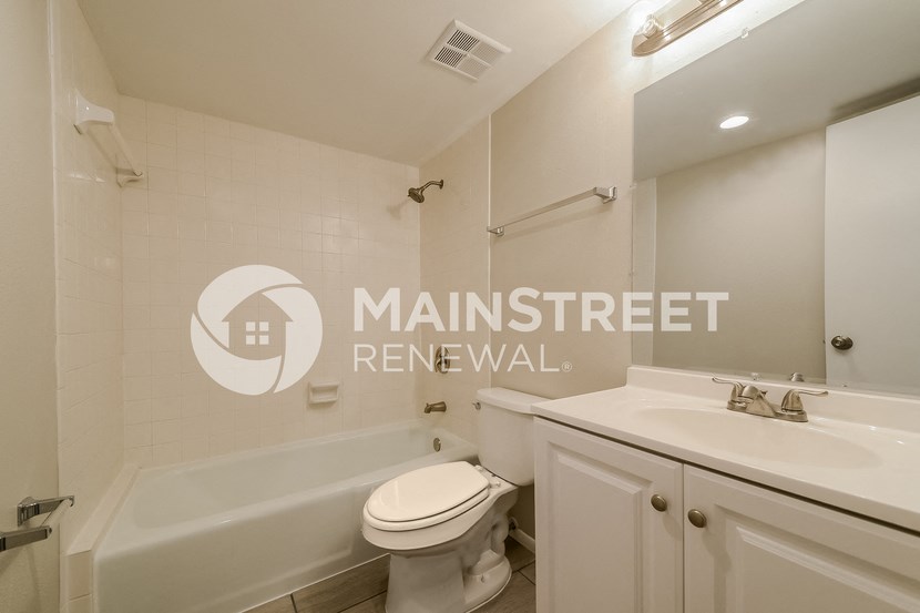 a bathroom with a sink toilet and a bath tub