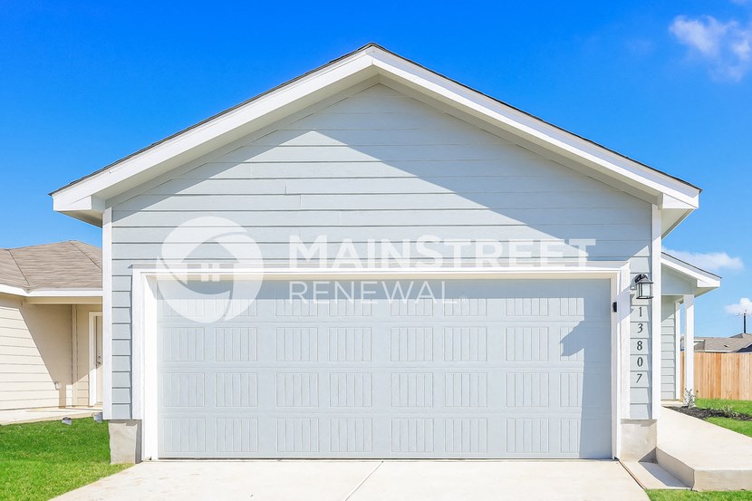 a garage with a white garage door on the side of a house
