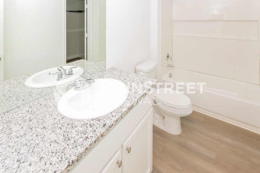 a bathroom with a sink and a toilet and a mirror