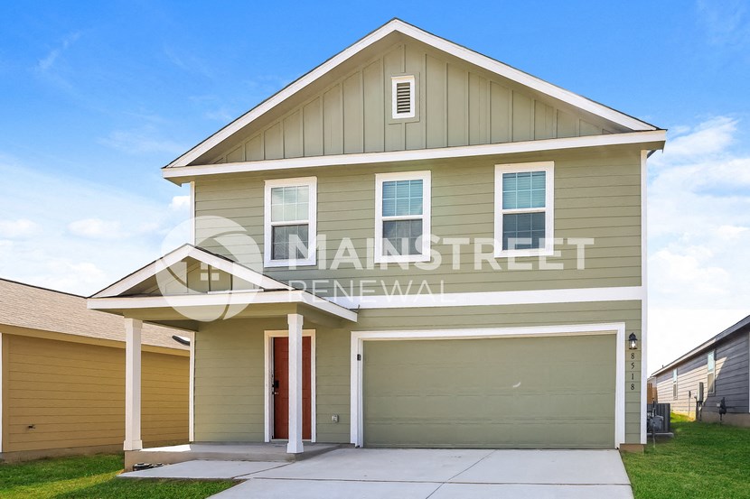 a single story house with a garage with a driveway