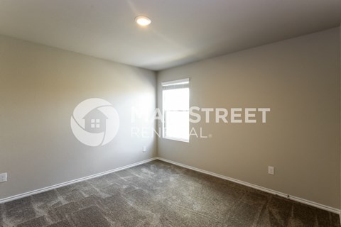 a living room with carpet and a window