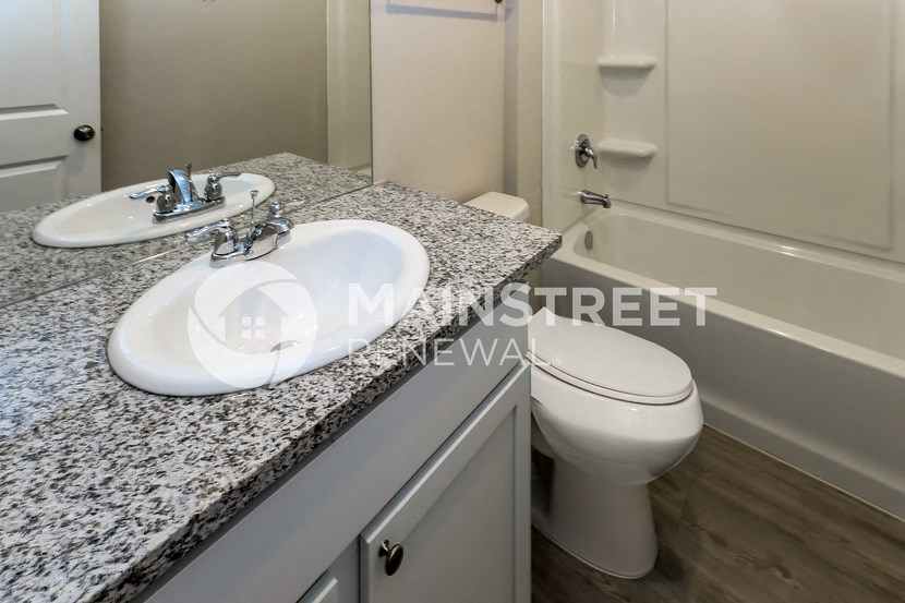 a bathroom with a sink and a toilet and a tub