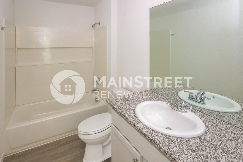 a white bathroom with a sink and a toilet