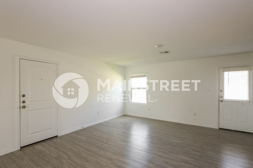 a hypothetical living room with white walls and a white door