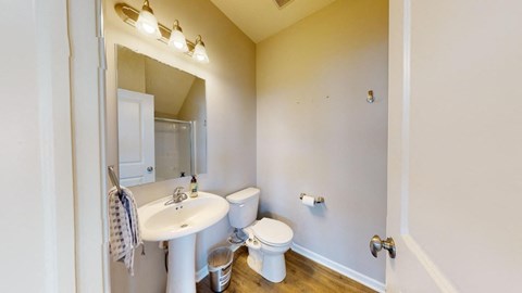 A white sink and toilet in a small bathroom.