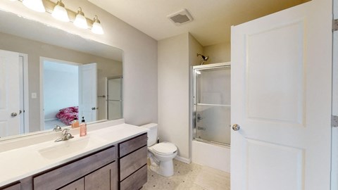 A bathroom with a white sink and a toilet.