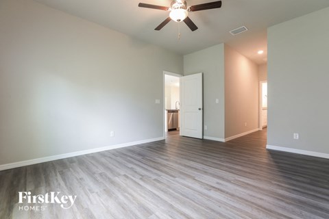 a living room with hardwood floors and a ceiling fan