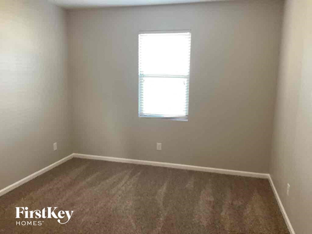 A room with a window and wooden flooring.