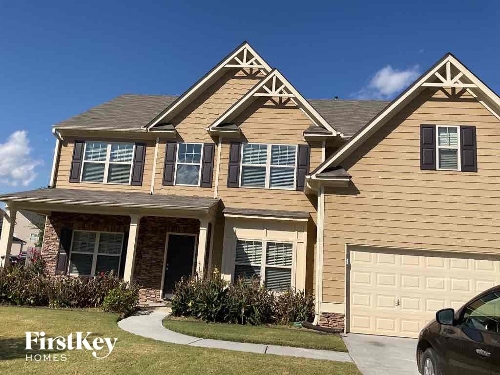 A house with a car parked in front of it.