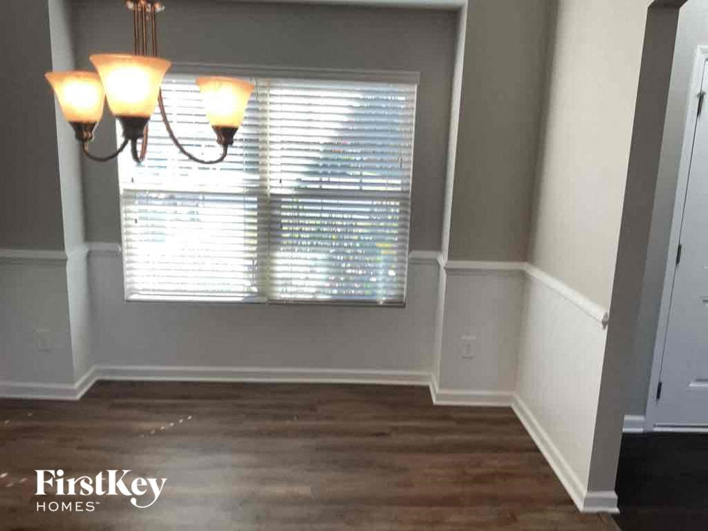 A room with a wooden floor and a chandelier.
