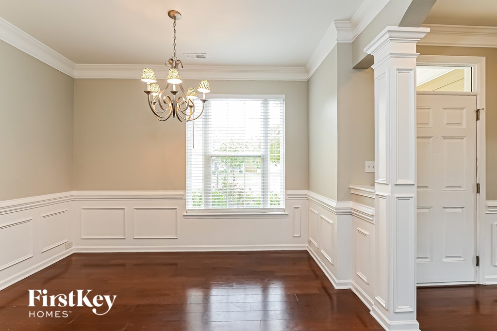 A room with a chandelier and a door.