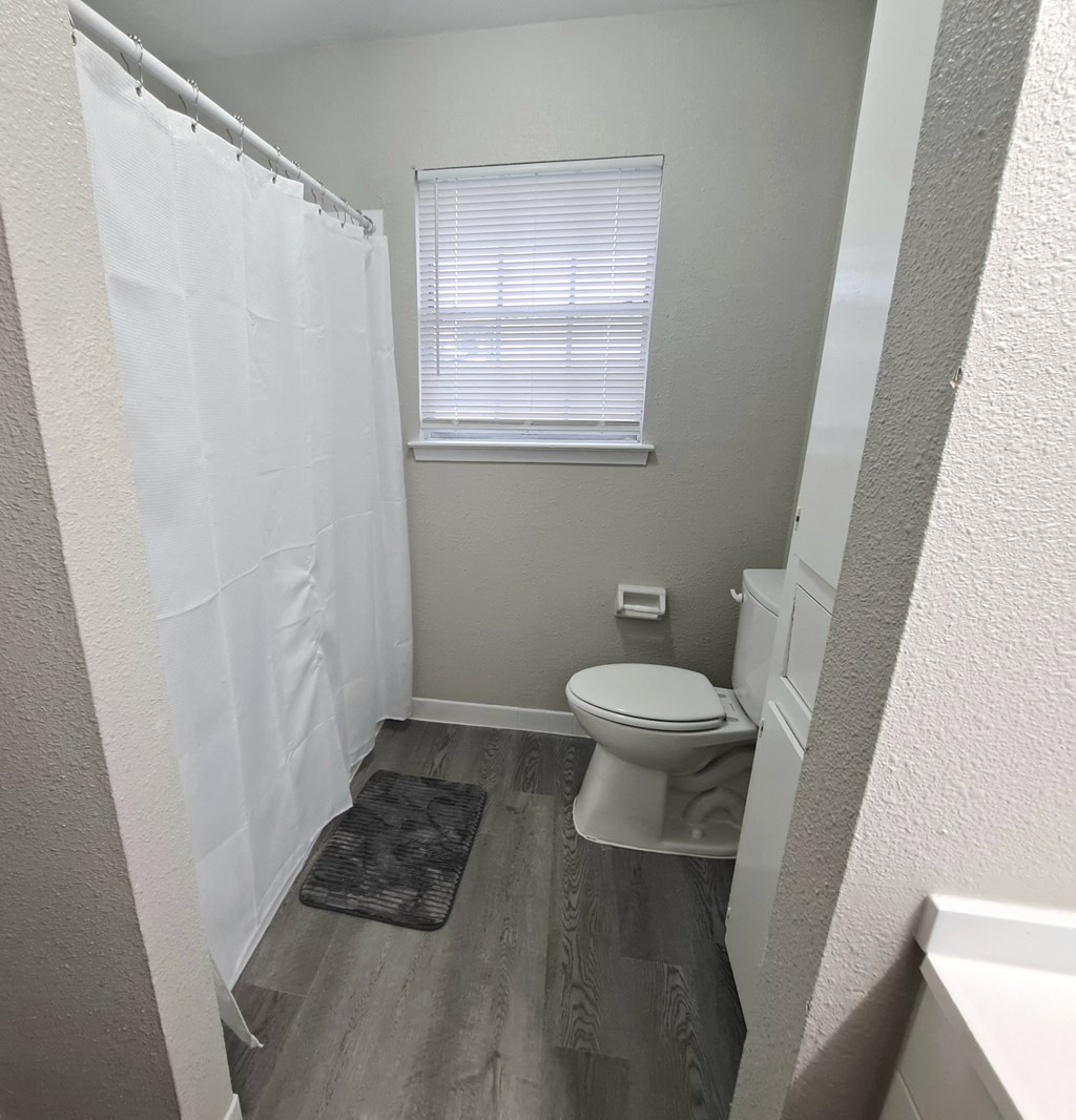 a small bathroom with a toilet and a shower
