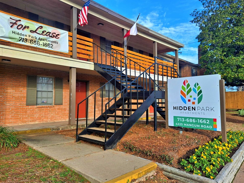 the front of a building with a sign and stairs