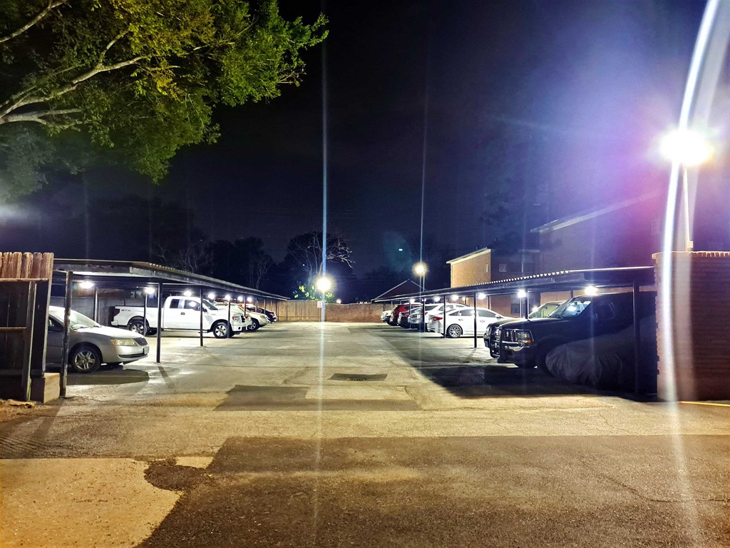 a parking lot at night with cars parked