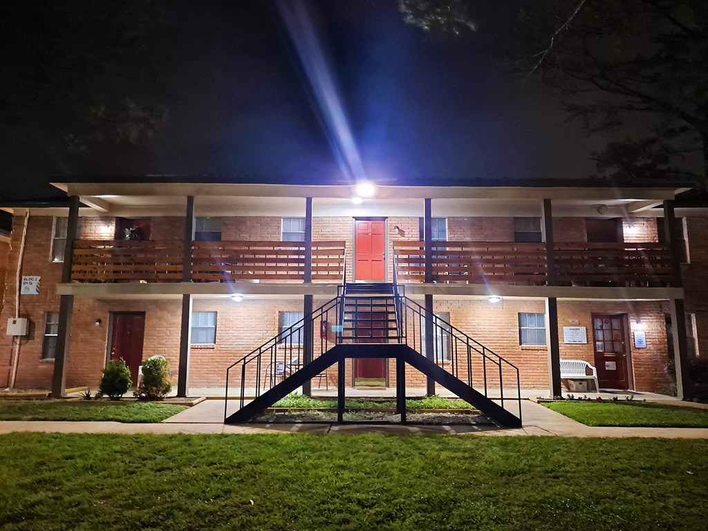 the front of a building at night with a staircase