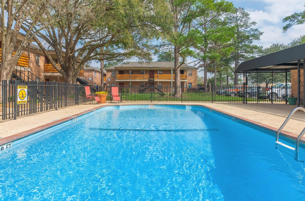 the swimming pool at our apartments with a blue pool
