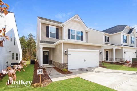 A two-story house with a garage is for sale.