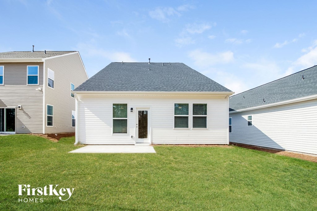 a white house with a yard in front of it