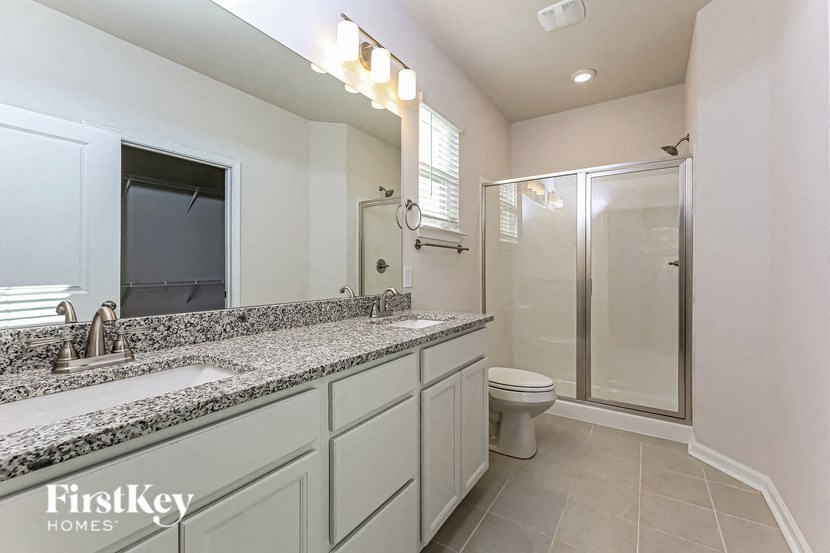 a bathroom with a sink and a toilet and a shower