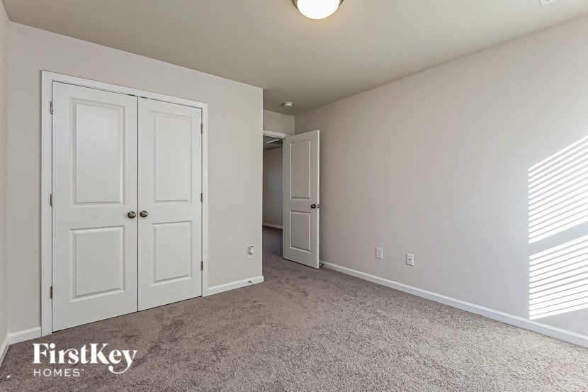 a bedroom with two closets and a door to a hallway