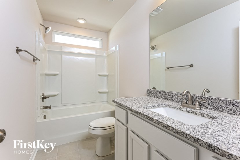 a bathroom with a sink toilet and a shower
