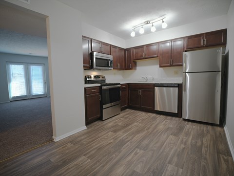 A kitchen with wooden cabinets and stainless steel appliances.
