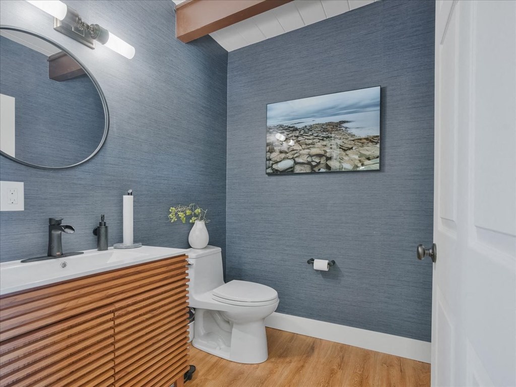 a bathroom with blue walls and a toilet and a sink