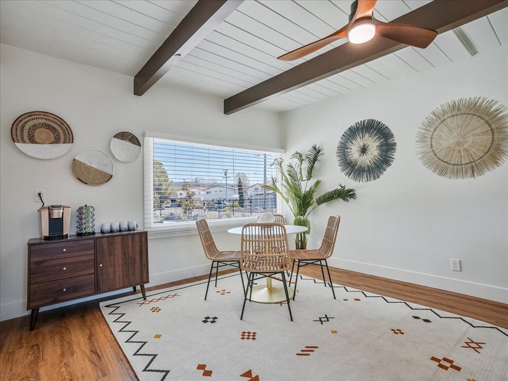 a dining room with a table and chairs and a window