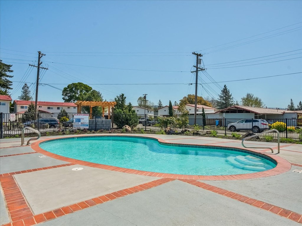 a swimming pool in a yard with houses in the background